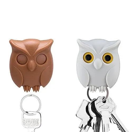 Magnetic wall key holder in white with attached keychains on a wall surface