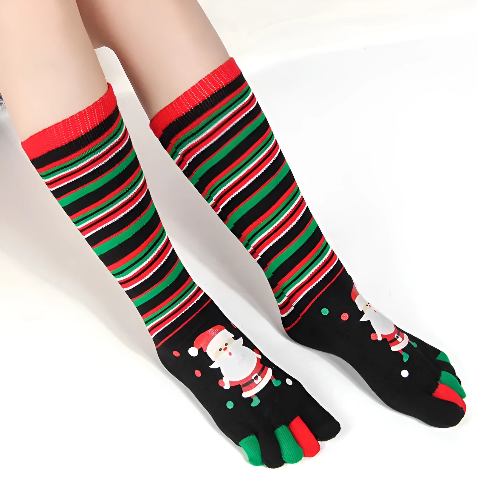 Christmas five finger socks with cartoon patterns in black, green, and white on a neutral background