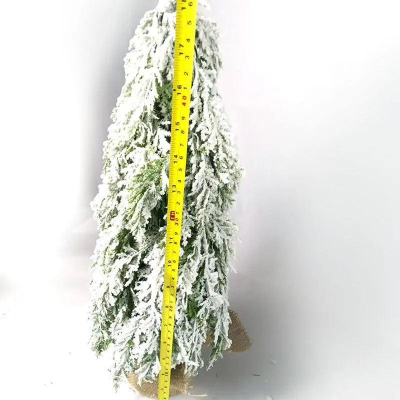 Small 24 inch white Christmas tree with built-in lights and simulated snow sprayer effect on branches