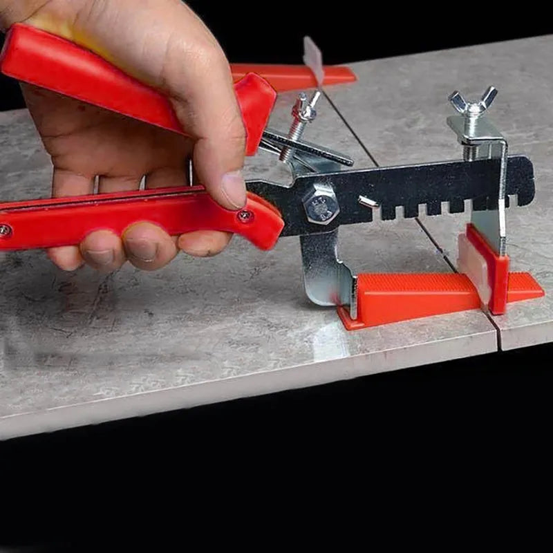 Red tile leveler aid with PVC handle and stainless steel clip measuring 23 by 11.5 centimetres