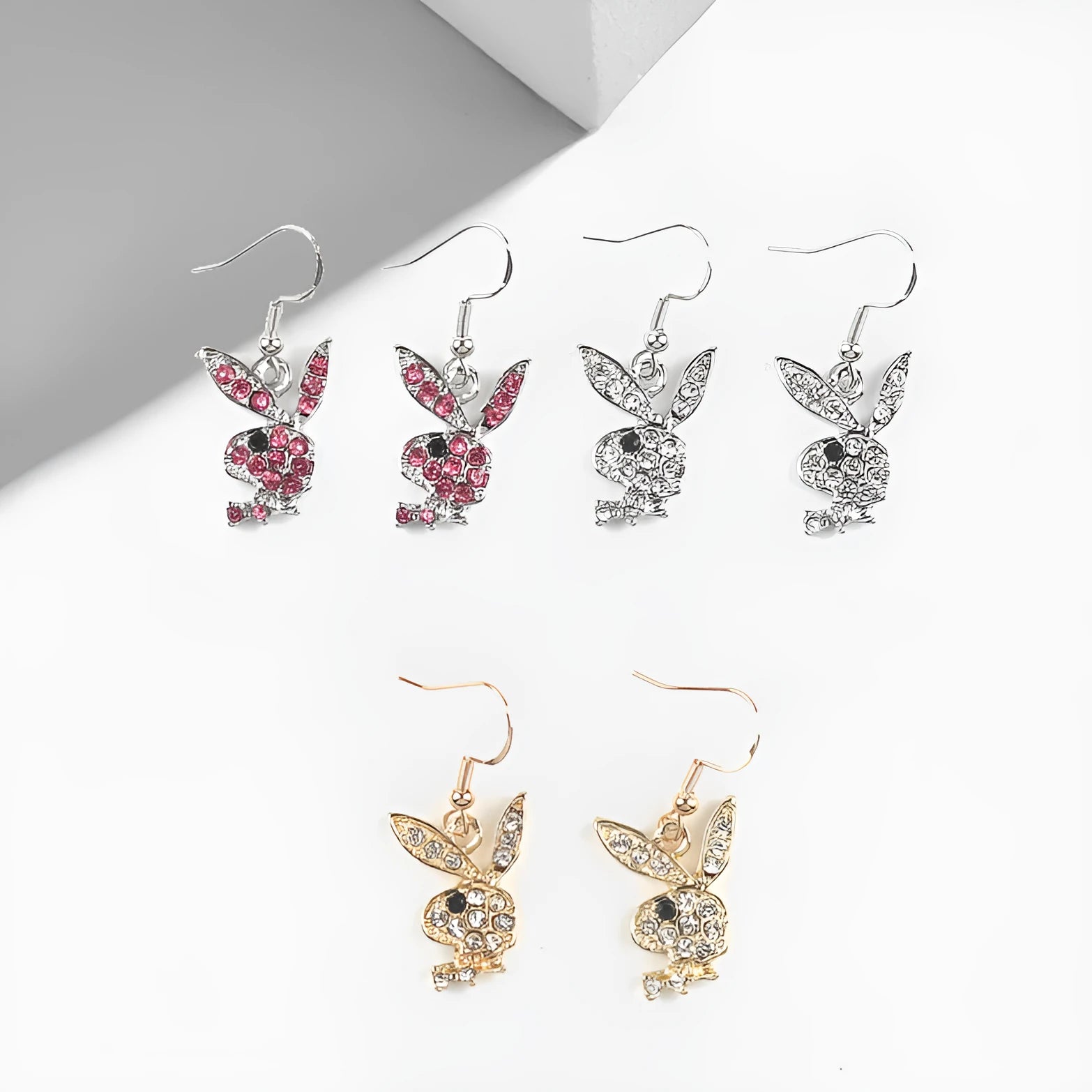 Close-up of cute full diamond rabbit stud earrings in alloy, showing gold, pink, and silver colour options.