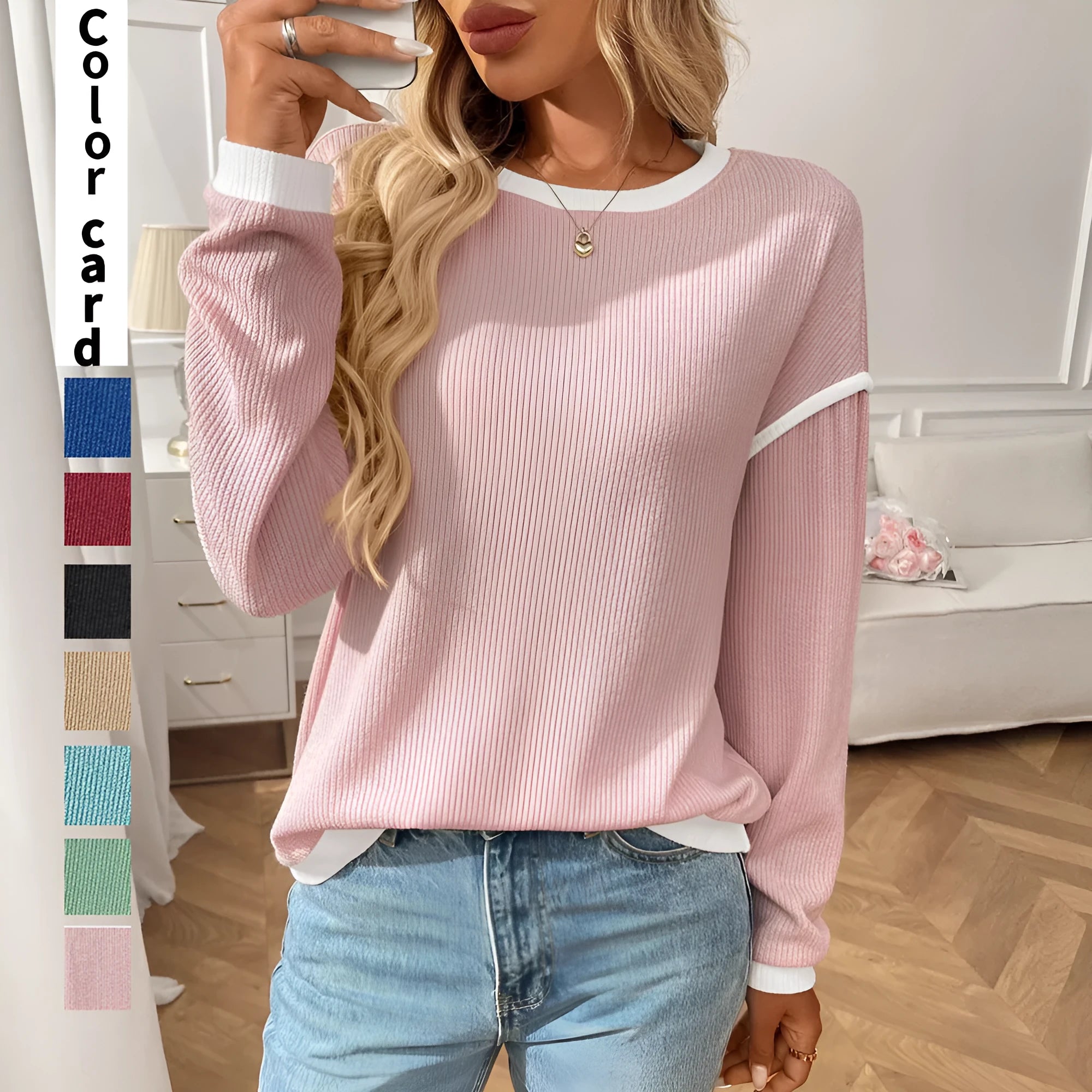 Women's loose round neck long sleeve polyester pullover top in light blue on a hanger.