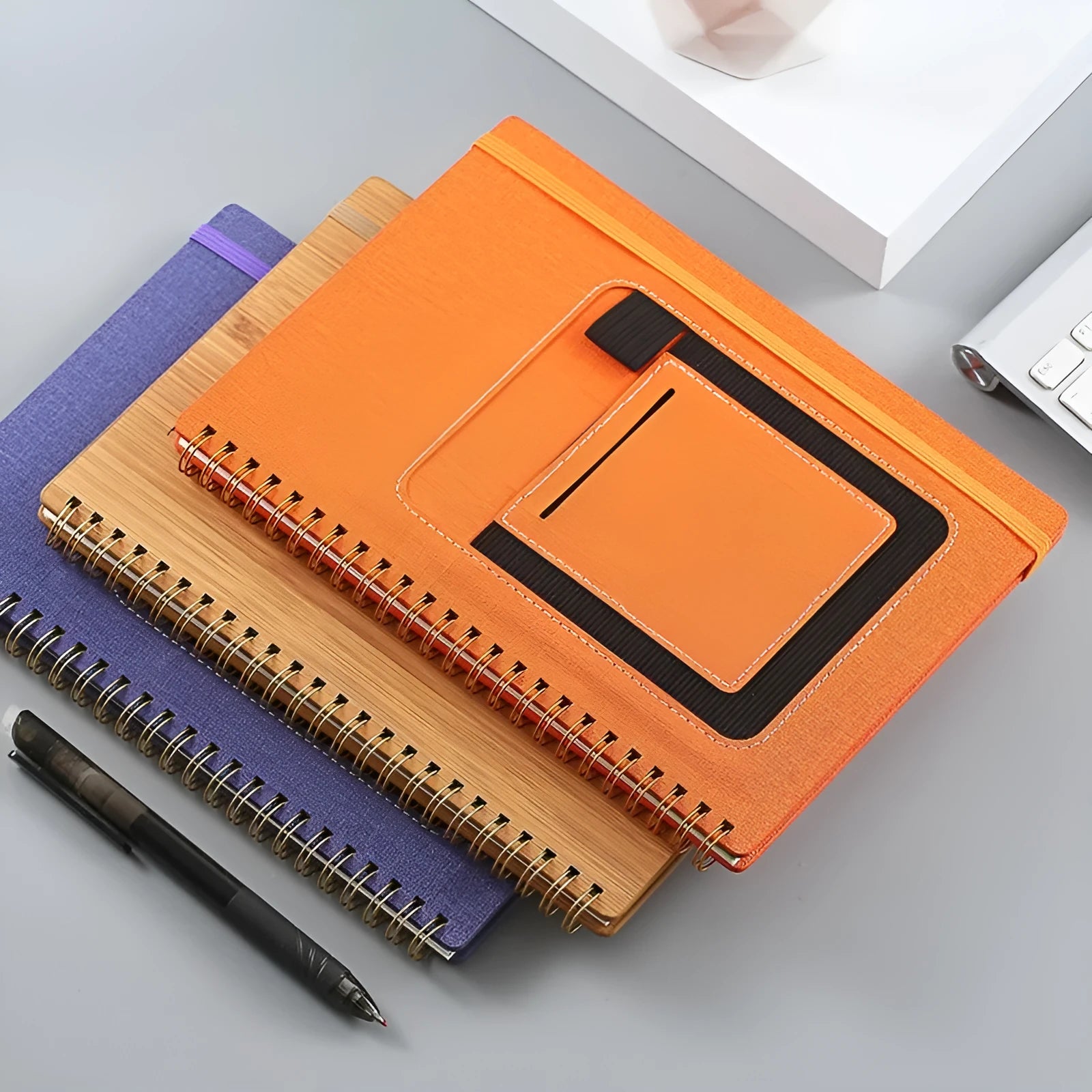 Erasable coil notebook with customisable cover options including black, blue, and wood grain designs.