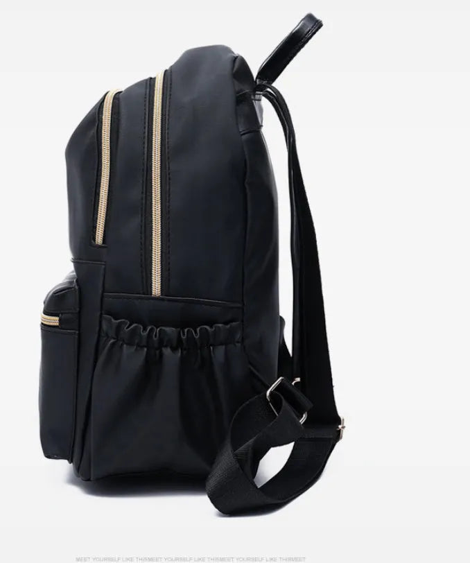 Black waterproof Oxford backpack for women, 34cm high, showing front view on plain background