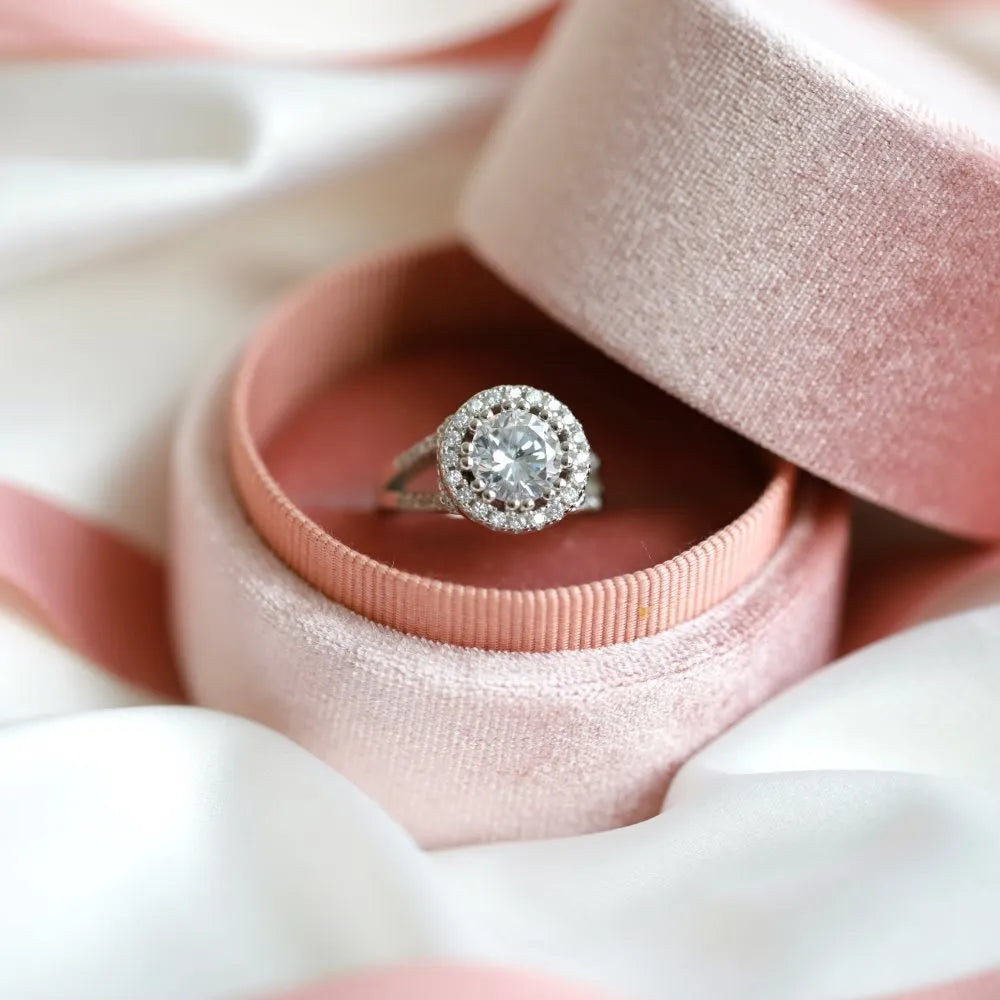 Silver ring with round rhinestone zircon centre on a plain background, women's affordable luxury style