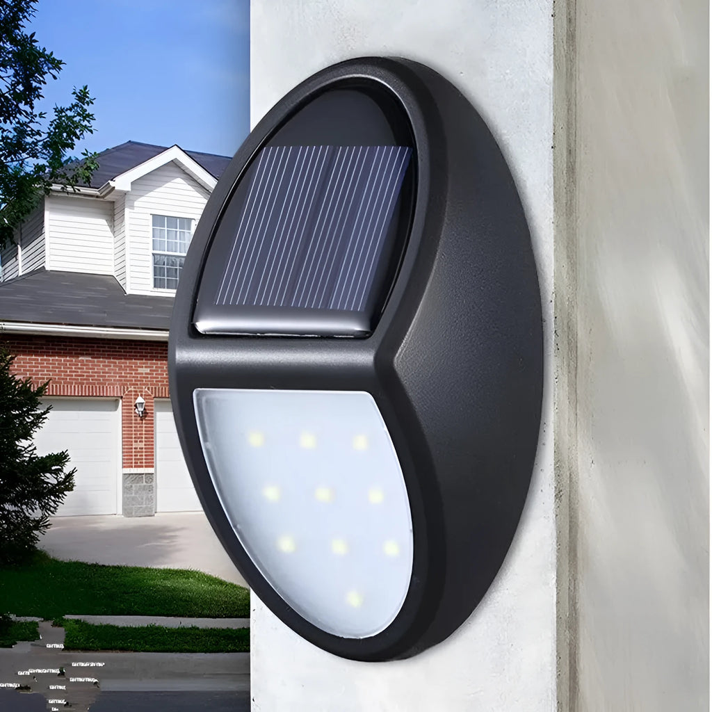Black rectangular LED solar wall light mounted on an exterior wall for automatic night-time illumination.