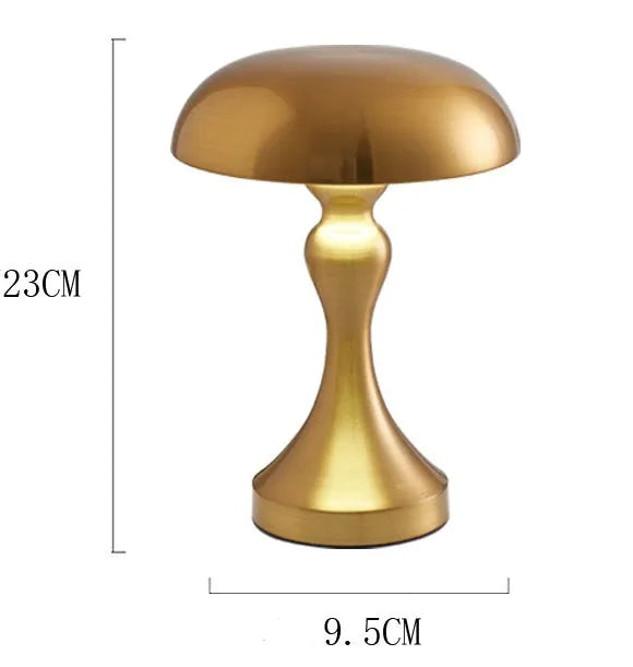 Metallic finish desk lamp with touch control and USB charging cable on a wooden desk