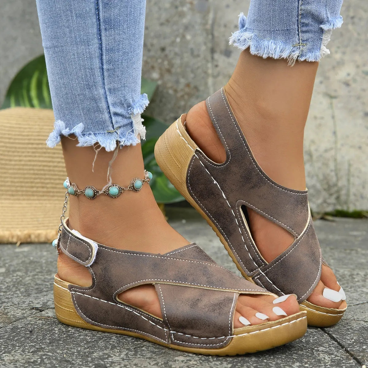 Women's brown Roman platform sandals with a skirt detail and Velcro strap.