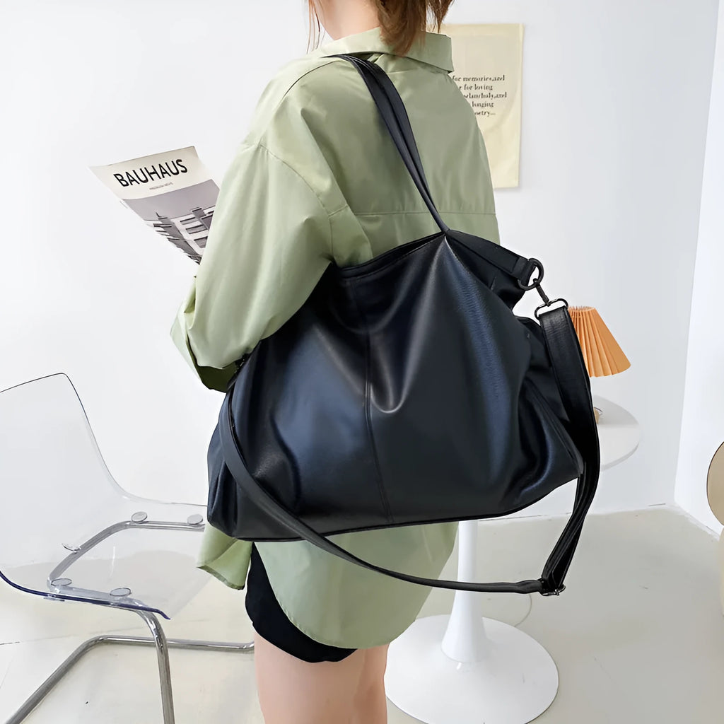 Large PU leather messenger bag with adjustable shoulder strap showing interior phone pocket organisation
