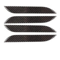 Four carbon fibre adhesive door handle protection patches for a Tesla Model S.