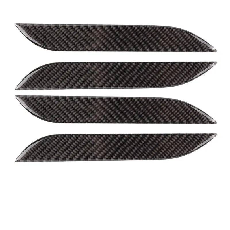 Four carbon fibre adhesive door handle protection patches for a Tesla Model S.
