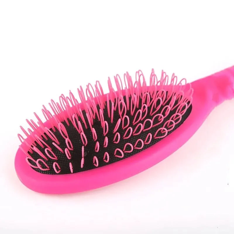 Black ring tooth hair extension comb with airbag cushion handle on white background