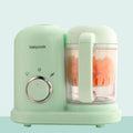 Green baby food processor with steamer and blender functions, double mixing blades