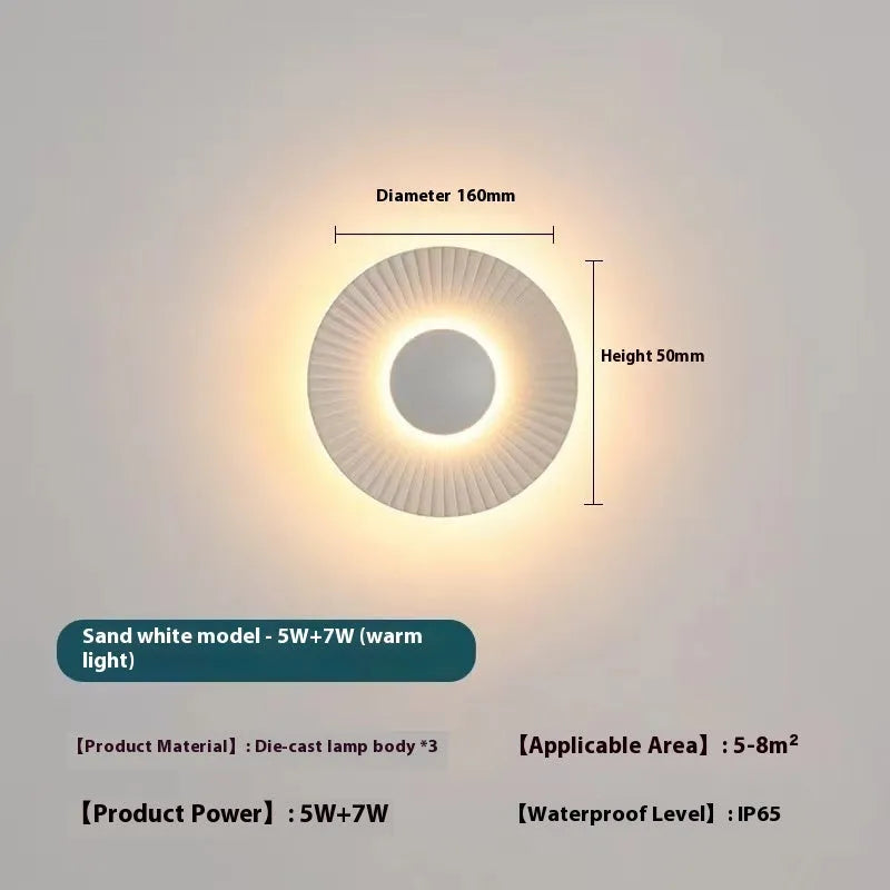 Round aluminium LED wall lamp in a choice of six colour finishes for bedroom or living room.