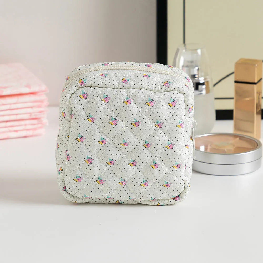 Small floral polyester key storage wallet with sewing thread detail in multiple colour patterns.