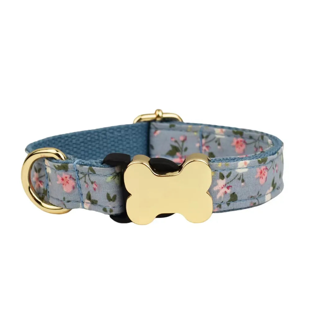 Flat nylon dog collar with grid print and a silver bone-shaped metal buckle on a green background.