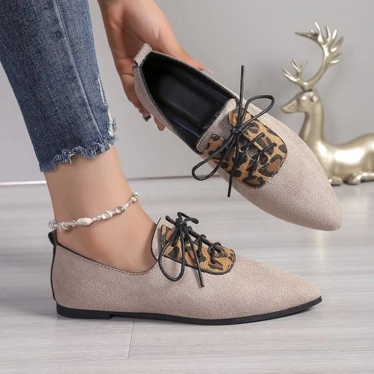 Beige leopard print women's pointed toe pumps on a white background, side view.