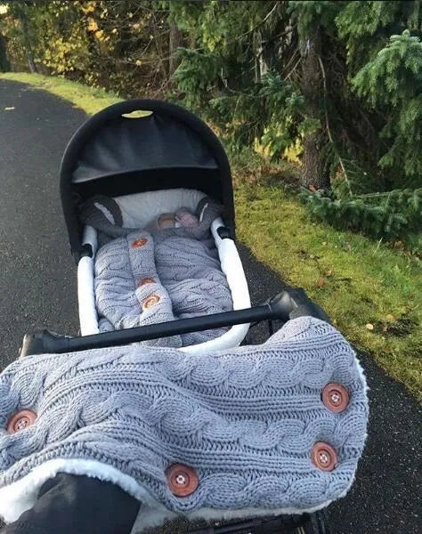 Baby sleeping bag in beige with button opening and matching pram handrail set