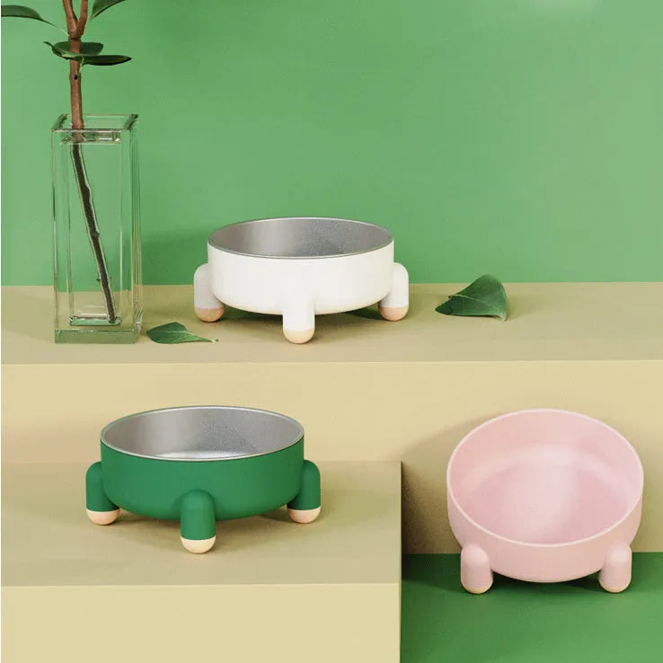 Green high-footed non-slip stainless steel bowl for dogs and cats on a floor.