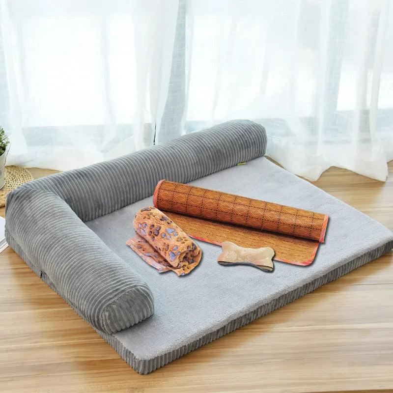 Corduroy pet sofa dog bed with bolster sides, shown in grey colour on a wooden floor