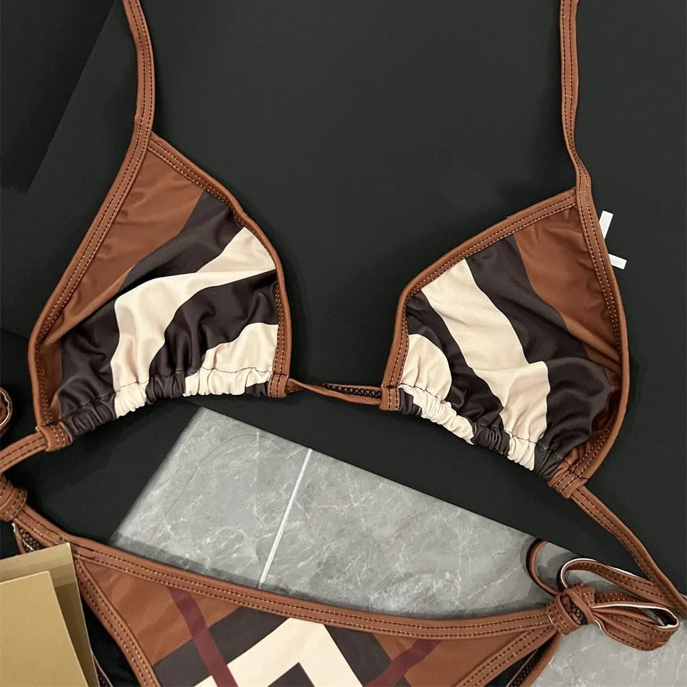 Women's black and white floral bikini set with split briefs on a beach