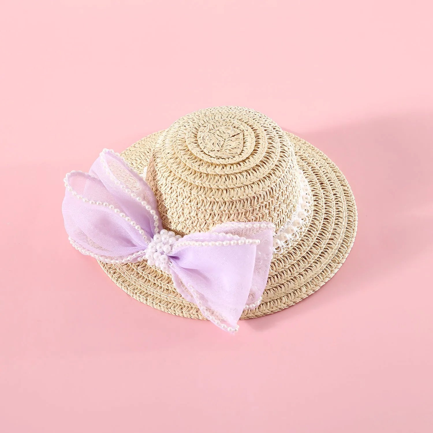 Woven Lafite leaf cat hat with pearl butterfly bow on a pink background, showing S and M size options.