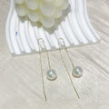 Fashionable long tassel pearl ear line drop earrings in gold finish on a white background