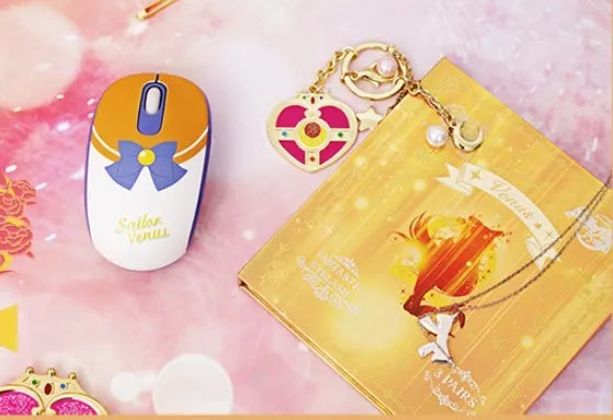 Pink Sailor Moon wireless mouse with USB receiver on desk