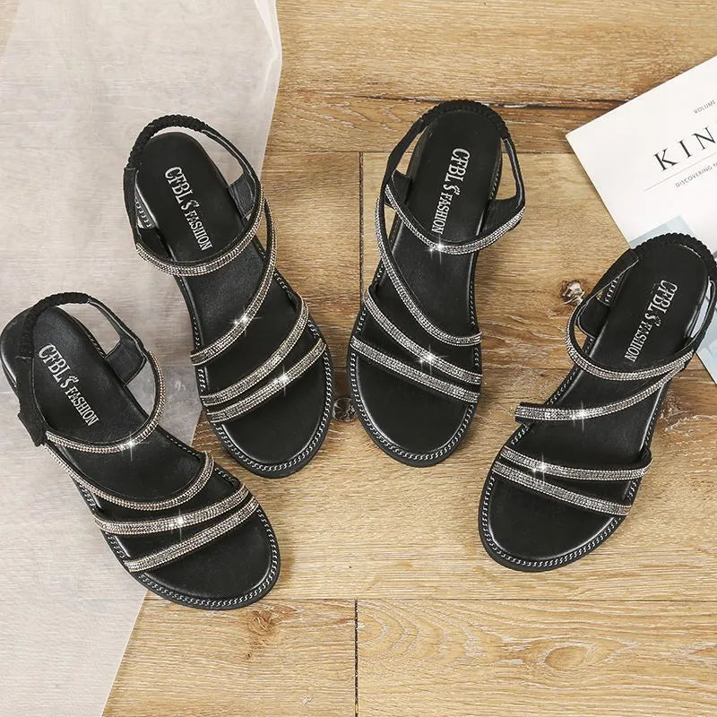 Women's silver Korean style flat sandals with elastic band and rhinestone decoration on a rubber sole.