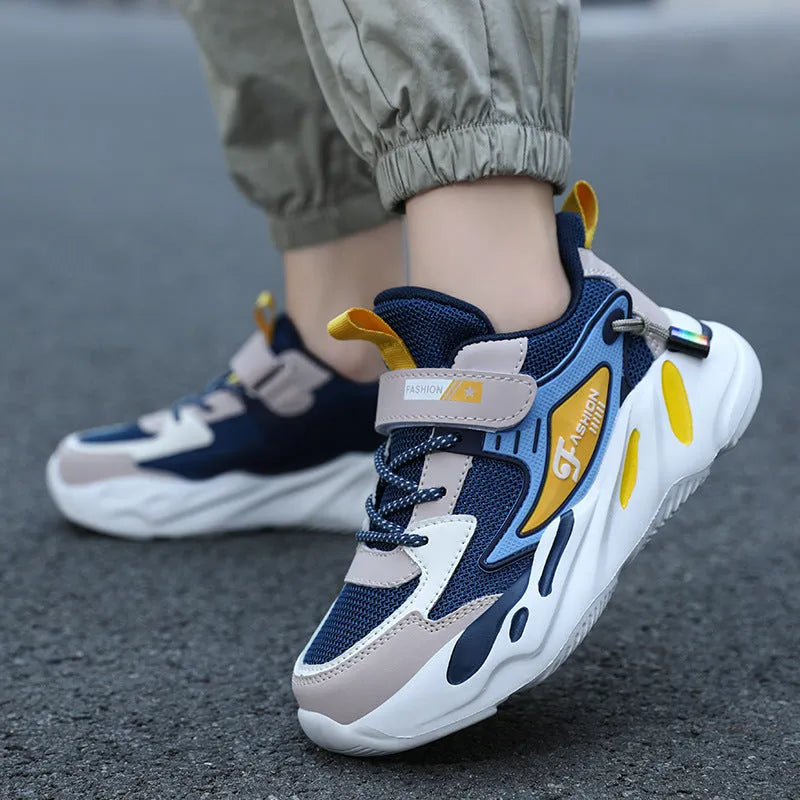 Boys dark blue and beige sports running shoes with Velcro strap and mesh upper.