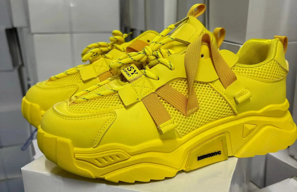 Women's purple and white platform mesh sports sneakers with front lace-up design on a plain background.