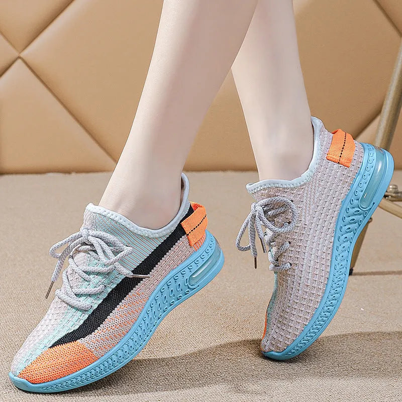 Women's purple low-top lace-up running shoes with round toe and plastic sole on a white background.