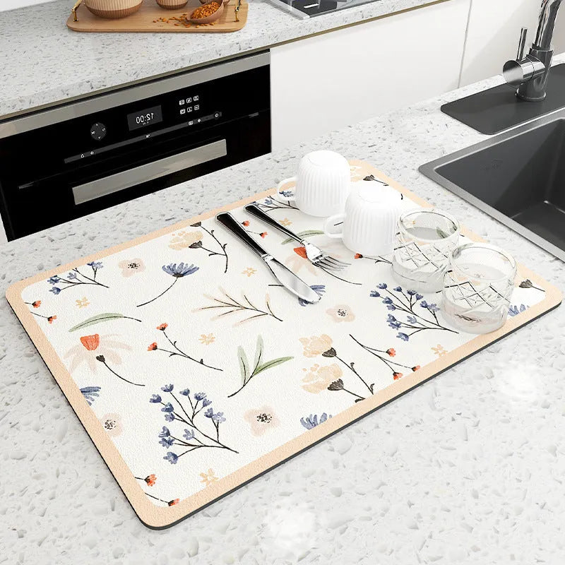 Square diatomite kitchen draining mat in camellia purple on a kitchen worktop, with a teacup resting on it
