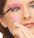 3 in 1 Mascara Shield Guard in pink ABS plastic showing lash comb edge