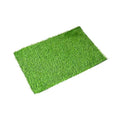 Green plastic emulational grass dog toilet mat on floor