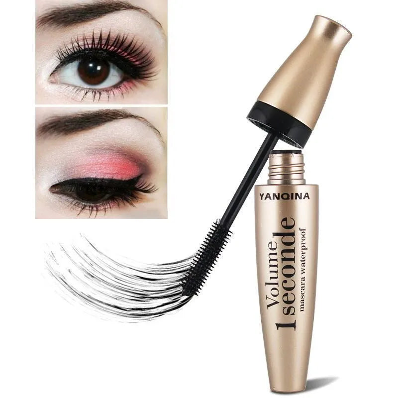 Gold tube black mascara in a vertical orientation against a light background