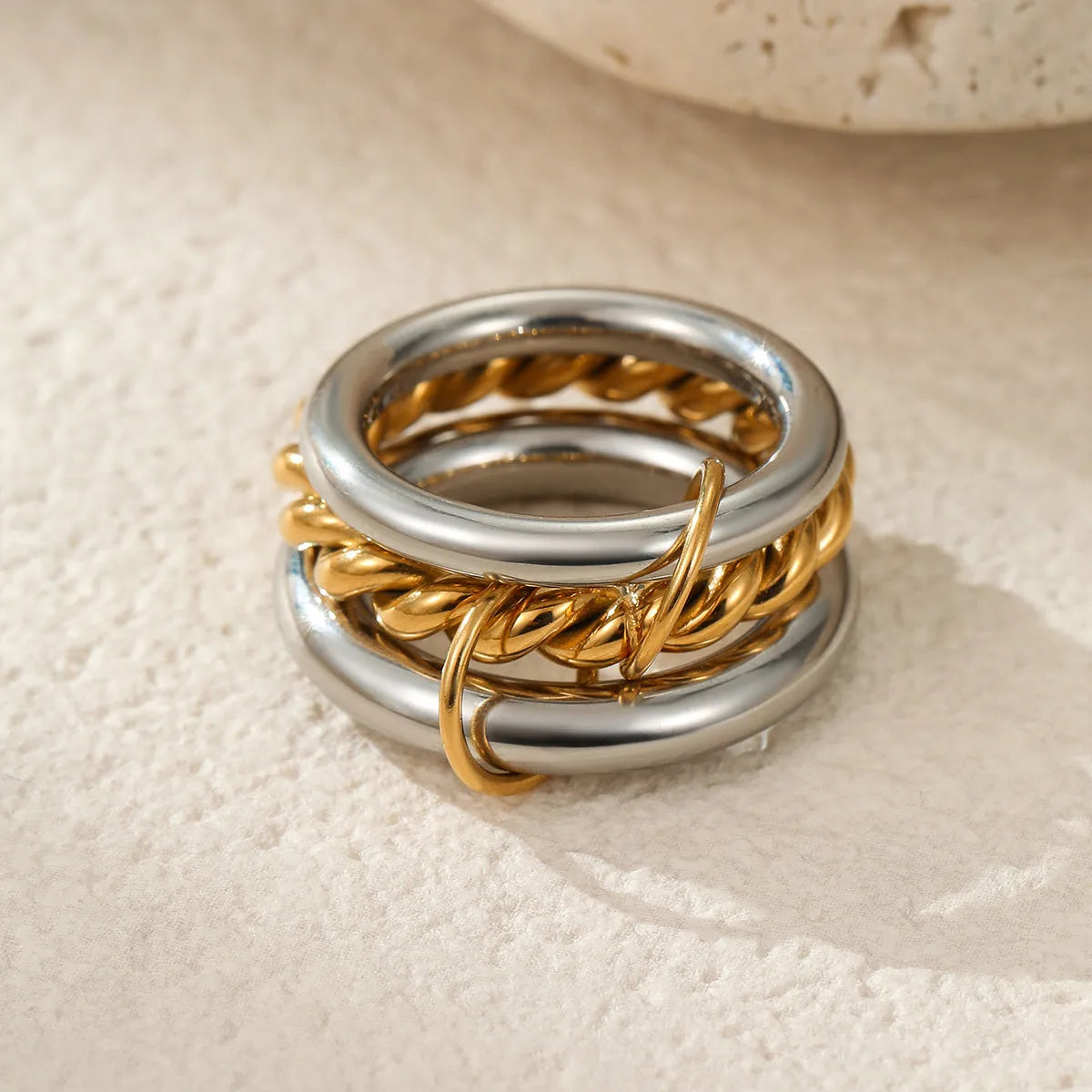 Three stacked stainless steel rings with 18K gold plating in matching design