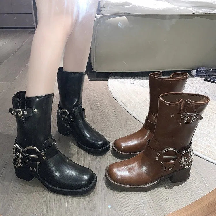 Women's black platform boots with belt buckle detail at mid-calf height