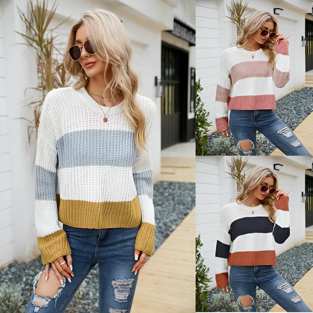 Woman wearing a short loose striped acrylic pullover sweater in a pink stripe variant.