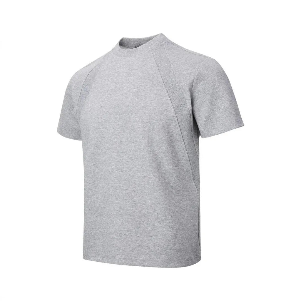 Man wearing a loose fit black short sleeve top with visible air layer stitching detail.