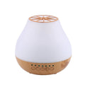 USB ultrasonic aroma diffuser with wood grain finish and colourful light on a wooden desk