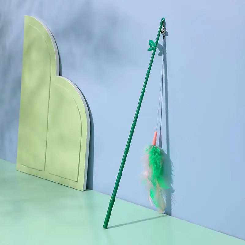 Green interactive cat feather wand toy with bells for play and training