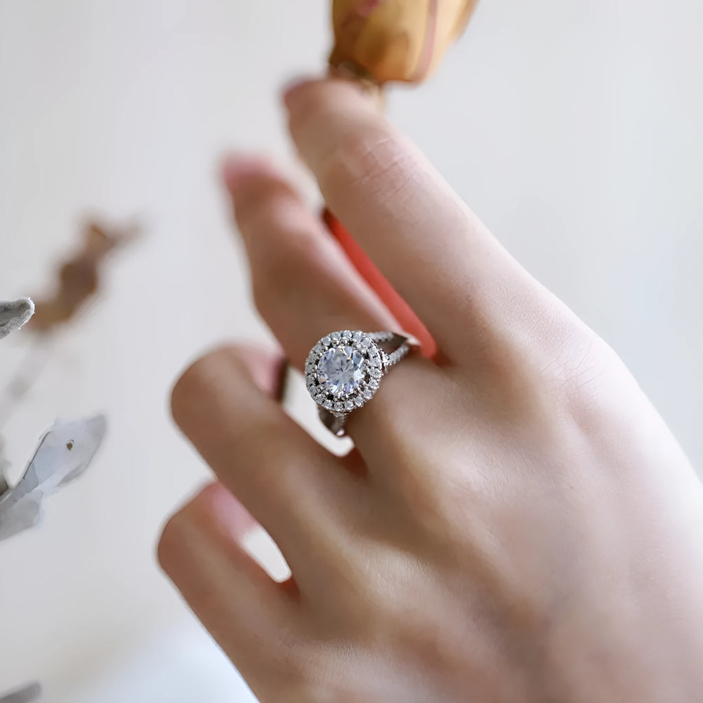 Silver ring with round rhinestone zircon centre on a plain background, women's affordable luxury style