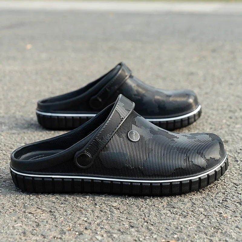 Men's casual beach sandals in black with flat heel, round toe, and EVA upper on a wooden floor