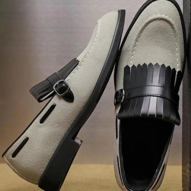 Men's gray denim loafer shoes with tassel accents, pointed toe, flat heel, on a white background