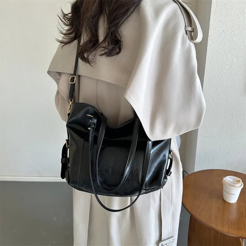 New retro commuter tote bag in soft PU, black colour, bucket shape with visible stitching and double shoulder straps