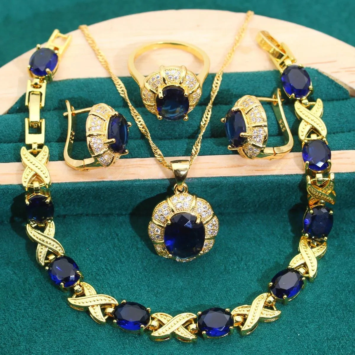 Gold plated zircon jewellery set with necklace, earrings, ring, and bracelet on display.