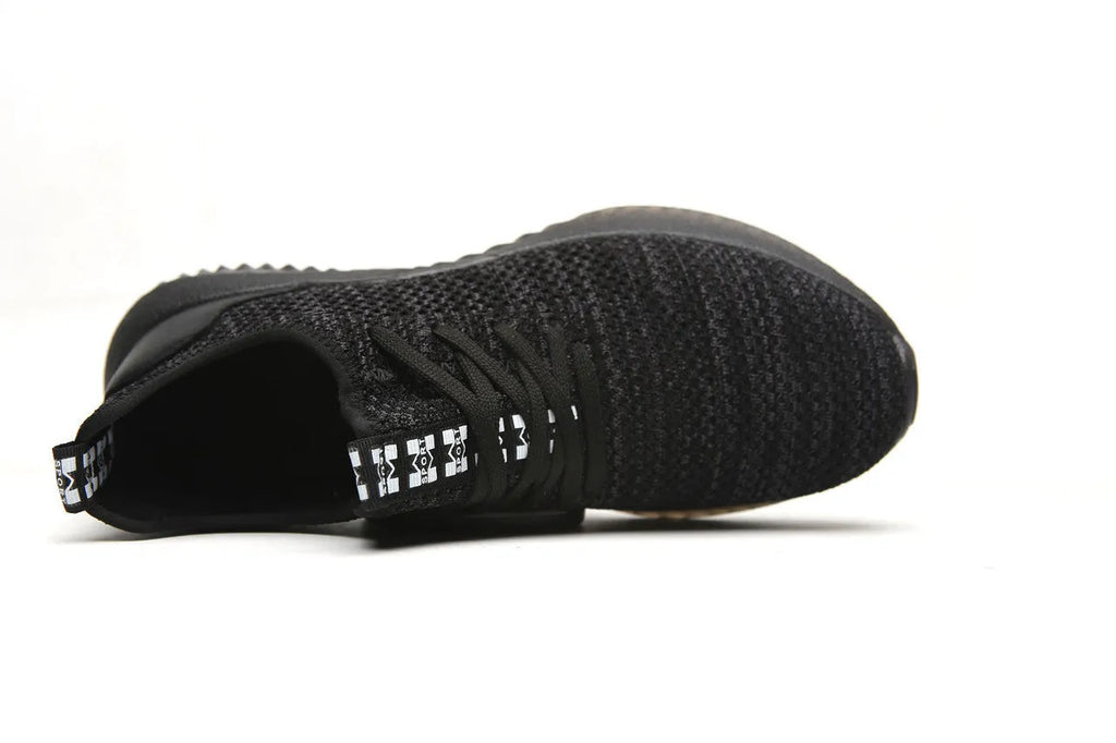 Black low-cut work safety shoes with a visible steel toe cap and textured EVA sole.