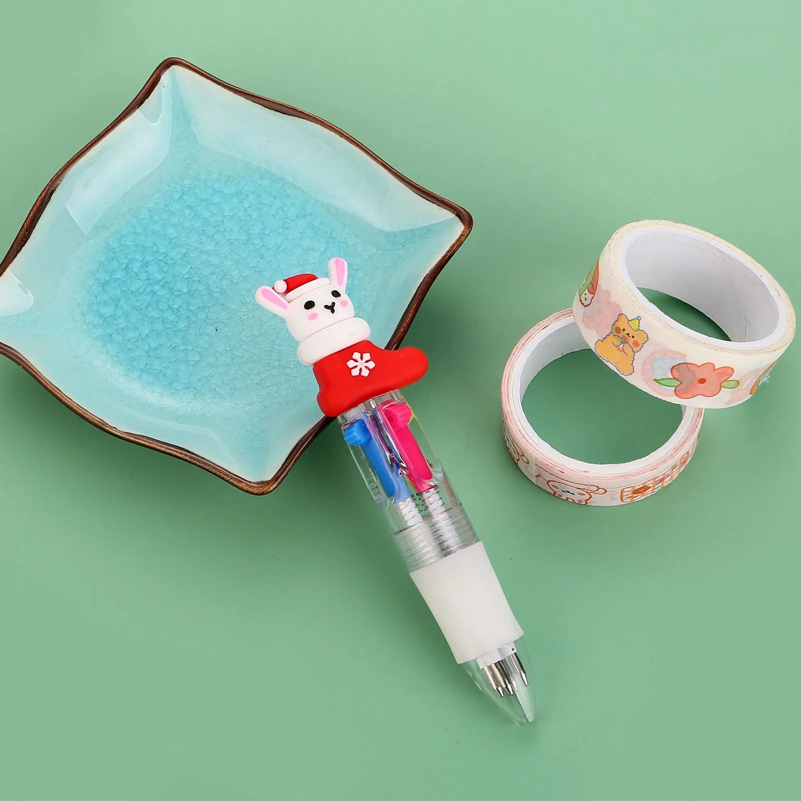 11cm long Christmas-themed four-colour ballpoint pen showing festive designs like reindeer and trees.