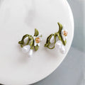 A pair of alloy camellia flower earrings for women, showing both the stud and clip styles.